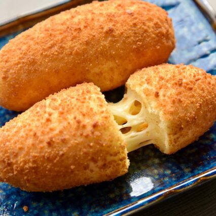 Air Fried Pulmuone Mozzarella Cheddar Fishcake Corn Dog on Blue Ceramic Plate