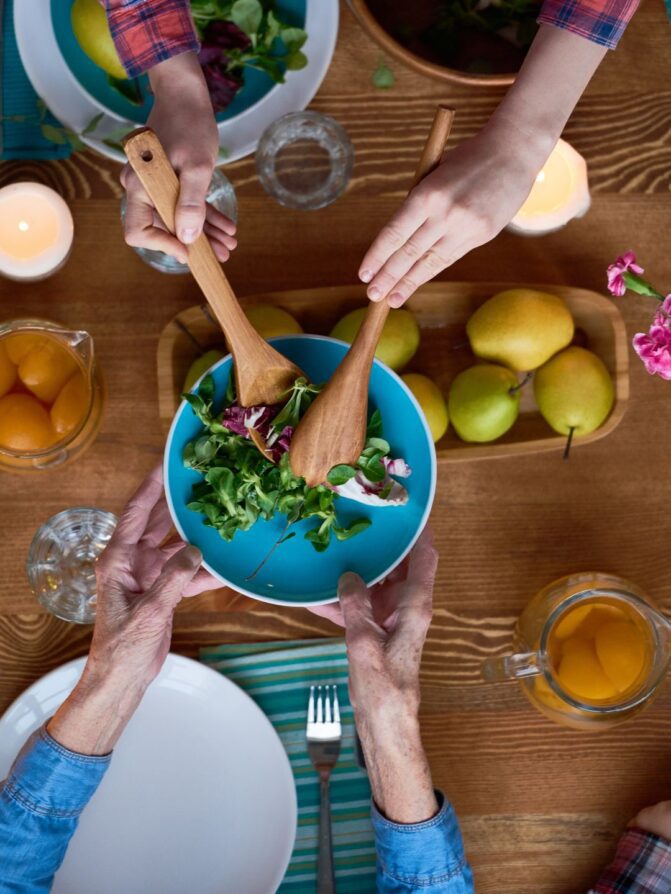 People sharing meal over a dining table | Uwajimaya