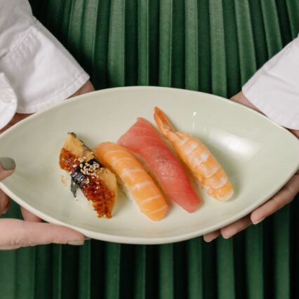 Woman Holding Plate of Sushi | Uwajimaya